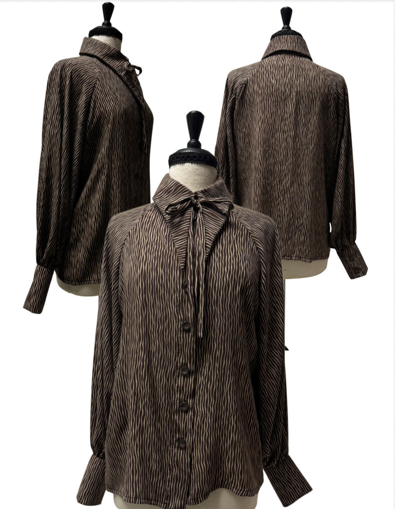 A brown and white vertically striped long-sleeve blouse with a tie-neck collar.