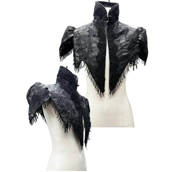 Medieval inspired caplet has beaded fringe and black trim detail.  