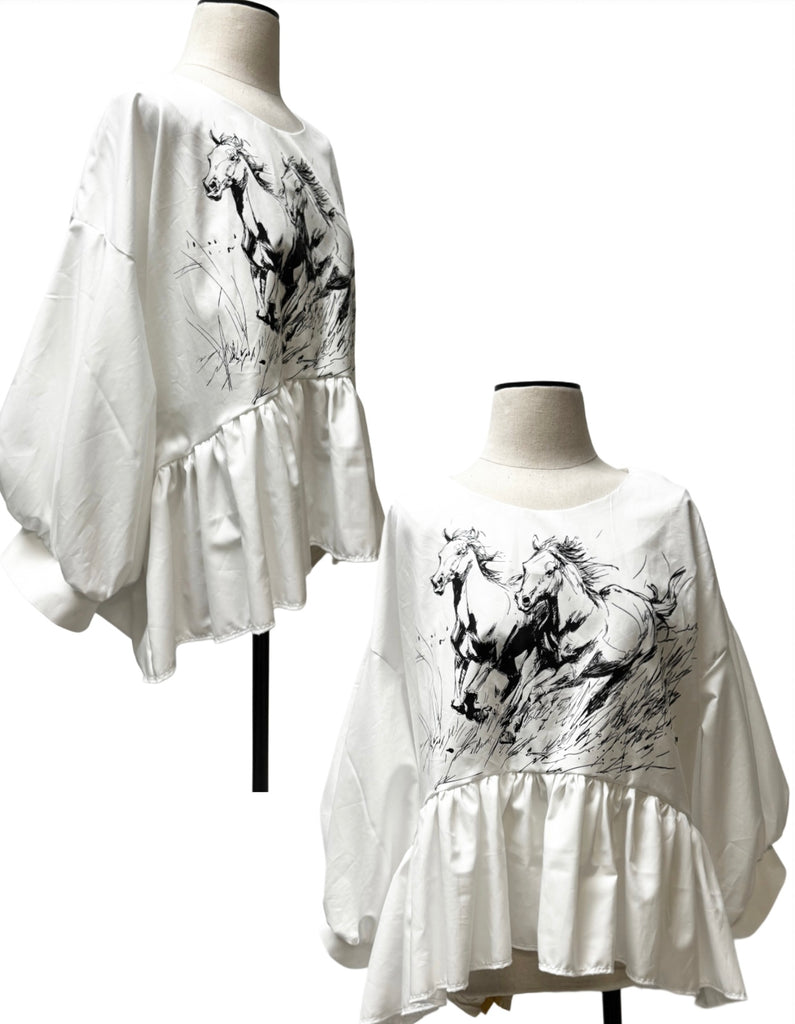 Two white dresses with black horse prints on mannequins against a white background