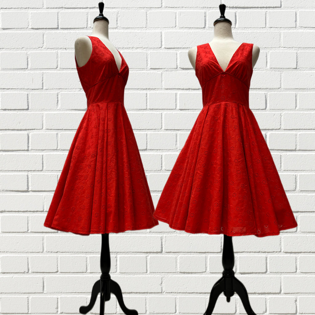 Mannequin forms showing the side and front profile of the Audrey Dress in Red Cotton Eyelet with a full circle skirt, side seam pockets, fitted bodice.