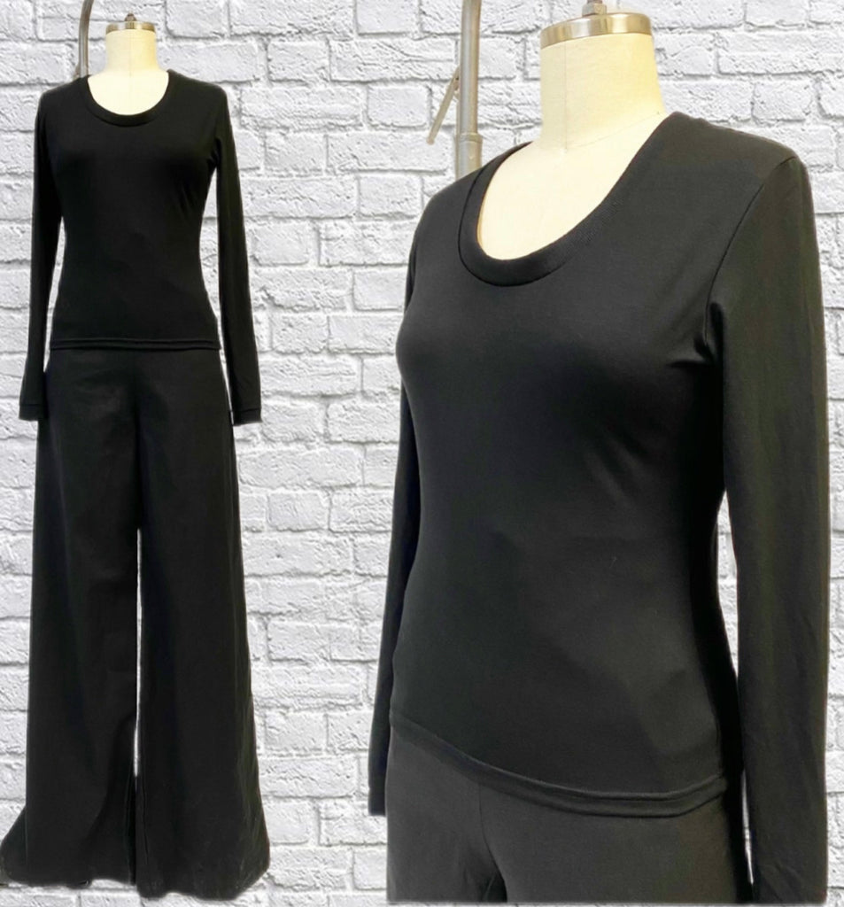 Long sleeve top in a Black Bamboo Knit with ribbed knit cuff and ringer neckline displayed on a mannequin form with black pants.