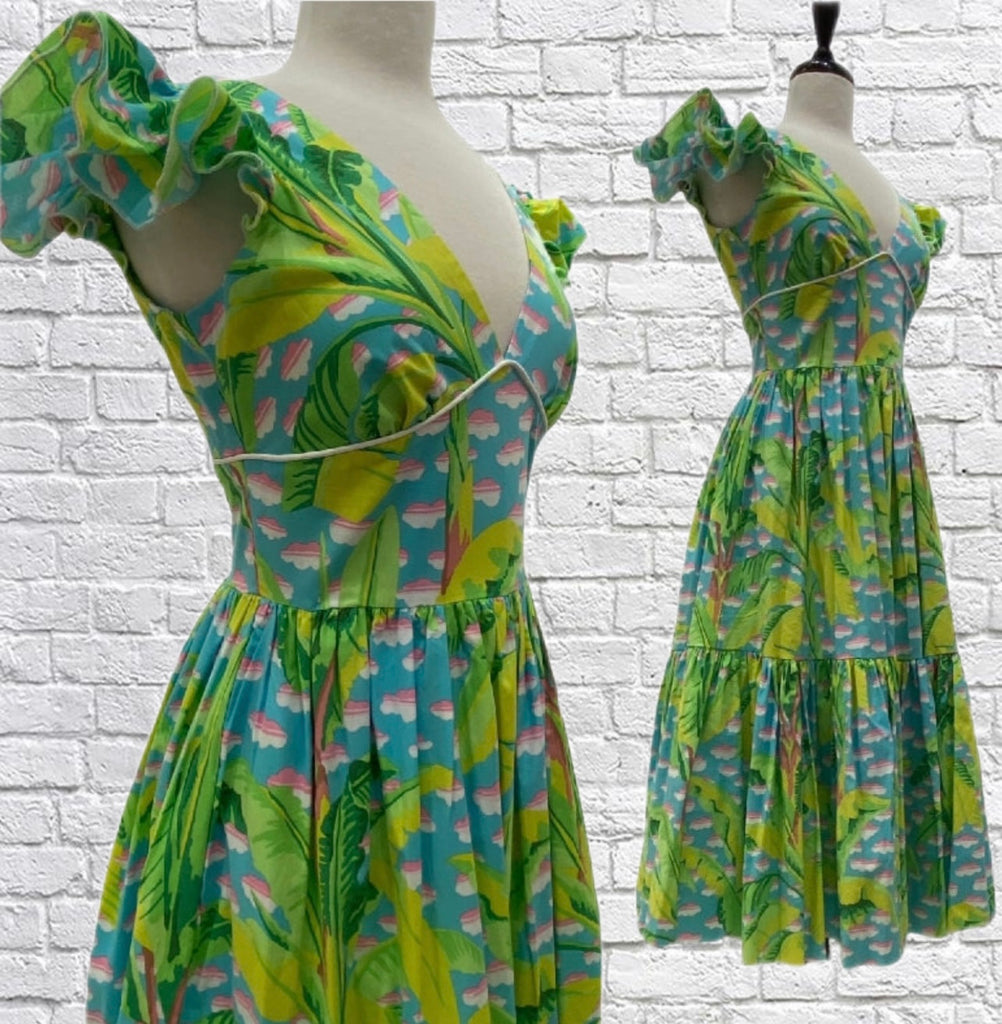 100% cotton blue and green dress with deep V-neck and back, ruffle cap sleeves, double gathered tiered skirt, side seam pockets, and full lining.