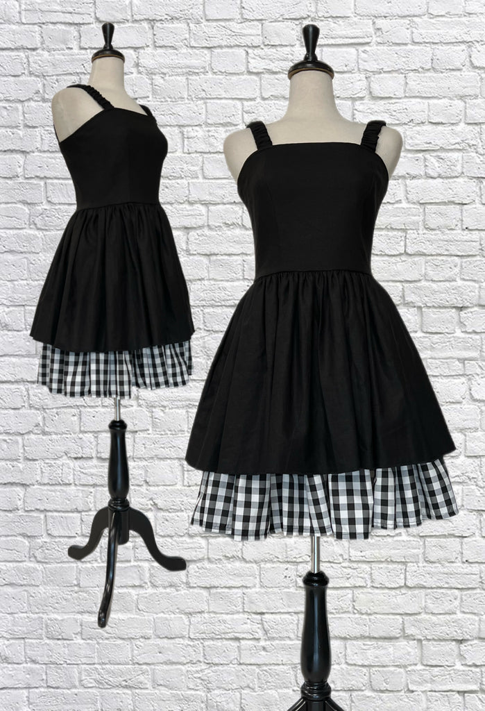Mannequin forms showing the front of the The Brigit Dress in Black Linen features ruched straps, side seam pockets, a back zipper closure, and the cutest peekaboo gingham lining.