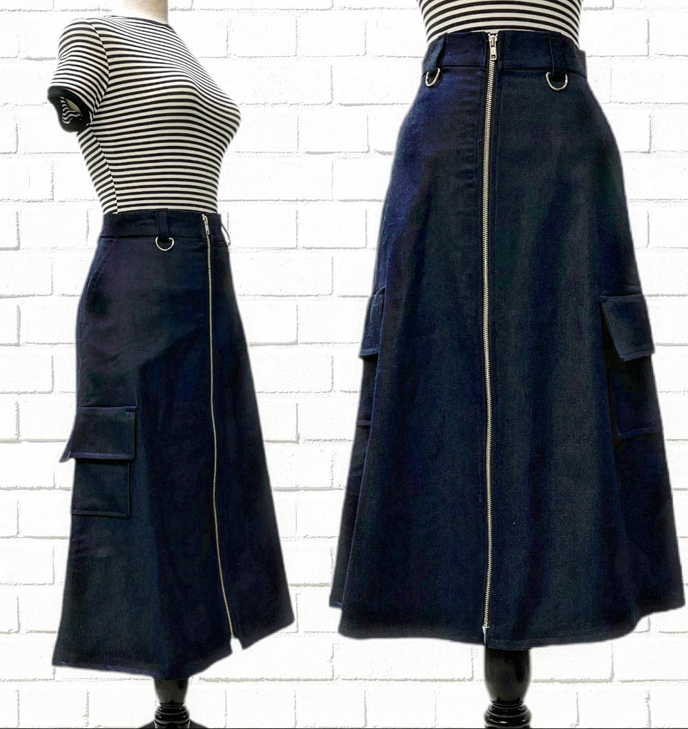Mannequin form shows the side and front details of the Candace Skirt in Blue Denim with Organic Denim, midi length, industrial Zip front, slash pockets, D-Ring d retail belt loops and side Cargo Pockets.