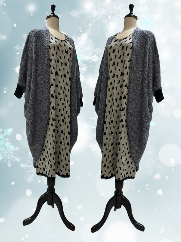 Cocoon sweater in a purple-grey over a pyjama shirt with patterned black cat heads.