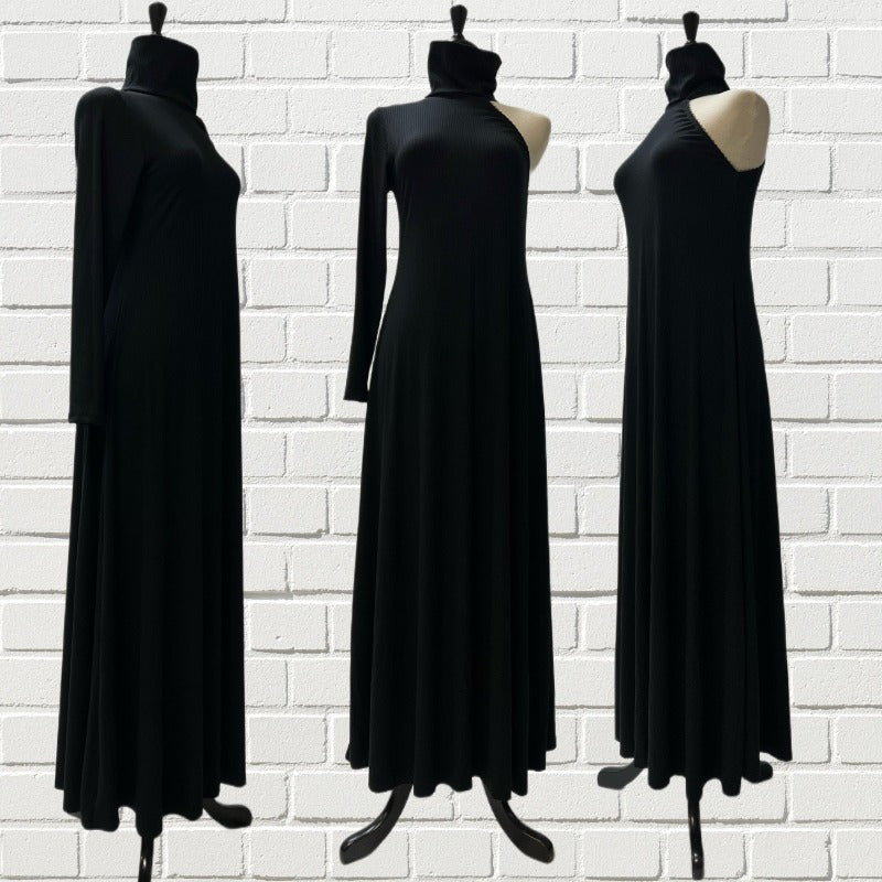 Mannequin forms in front of a white brick background showing a cold shoulder maxi dress in black ribbed bamboo knit in an A-line cut, with a turtleneck and lace detailing the cold shoulder arm. 