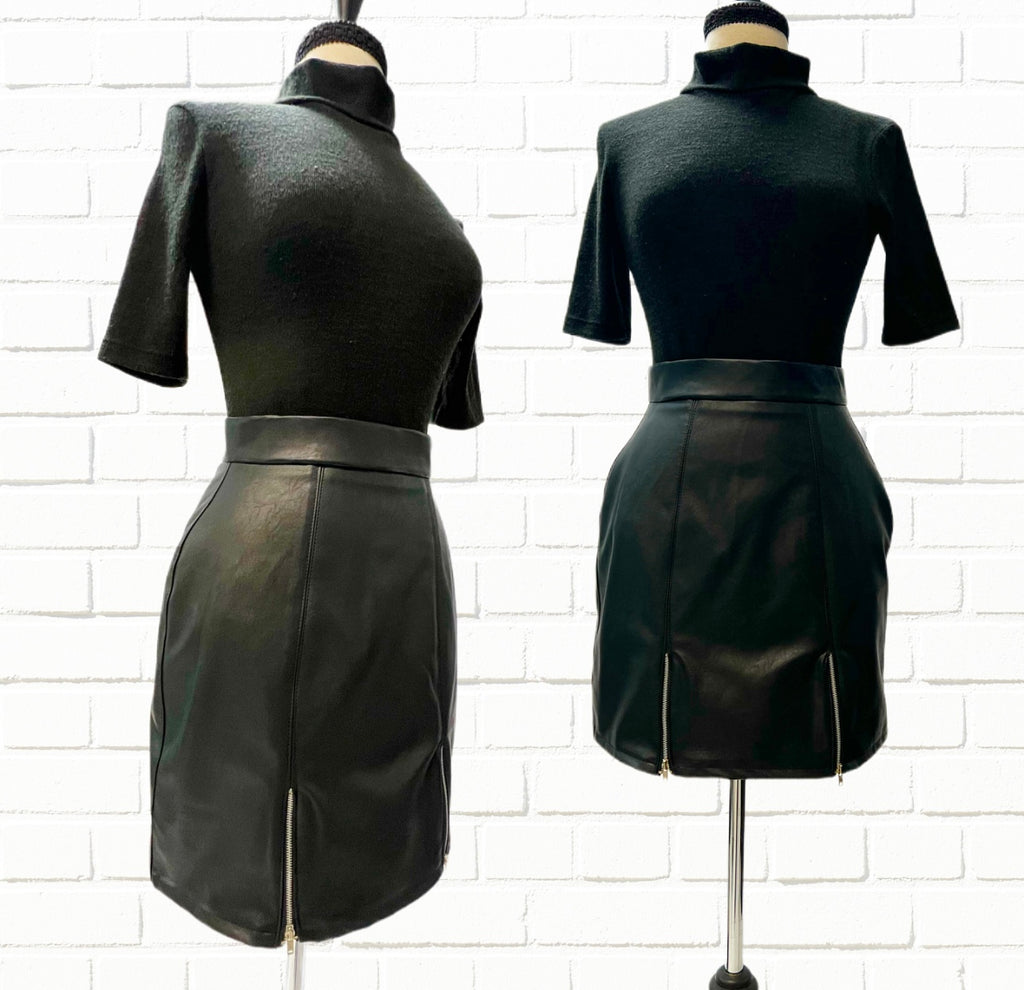 Mannequin forms showing the Edie skirt, a Mini skirt in soft faux leather with back zipper closure and two front zippered slits.