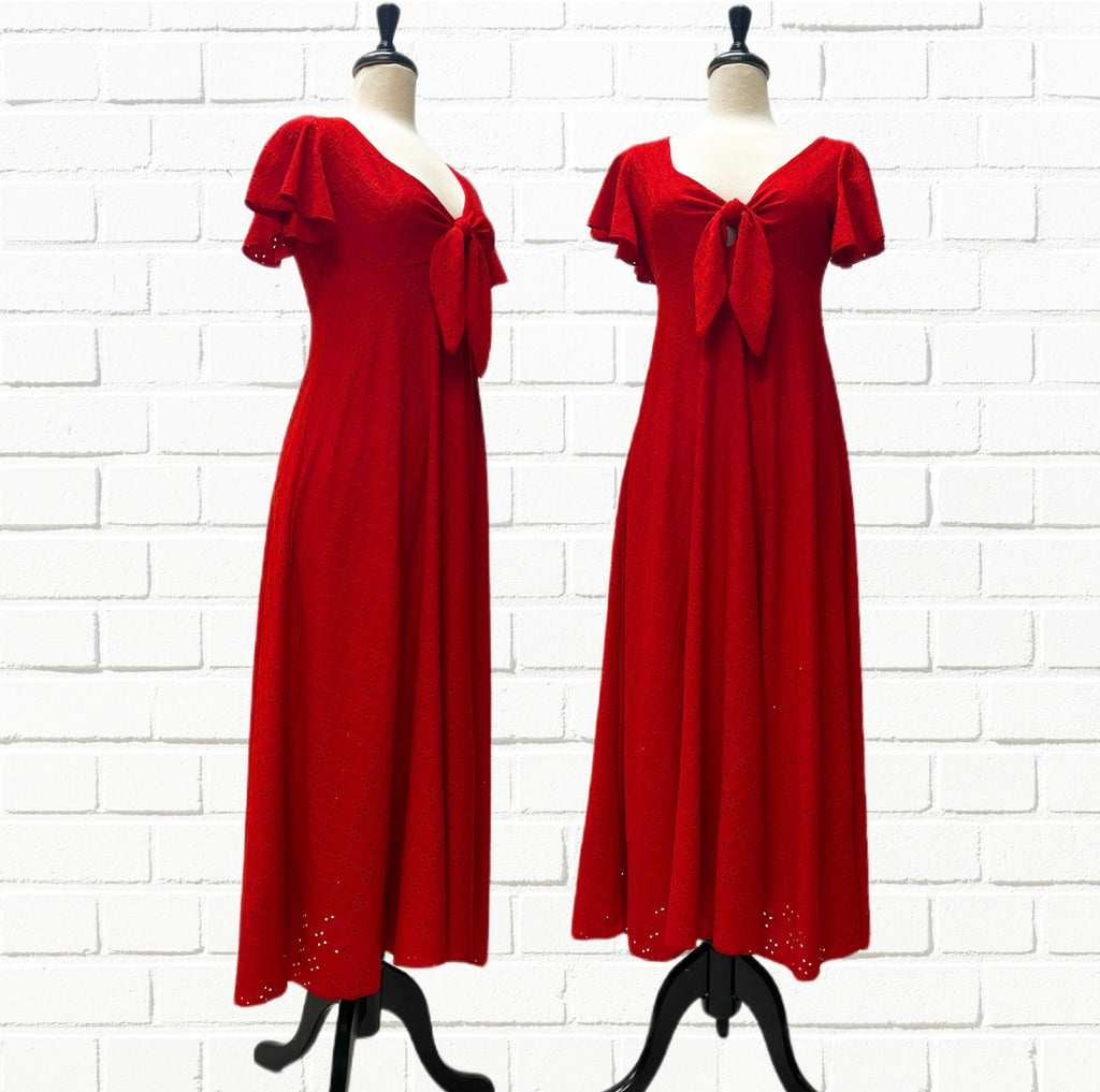 Mannequin forms showing the side and front profile of the Erin Dress in Red Eyelet with a tie up front, flutter sleeves, raise empire waist and A-Line, 1/2 lined skirt that skims over your body.