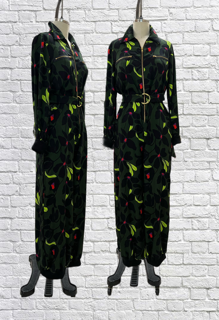 Mannequin forms showing the side and front profile of the Frankie Flight suit in floral print with pops of neon on dark green. Oversized with long sleeves, front zipper, gold hardware, bamboo ribbed knit sleeve and pant cuffs.