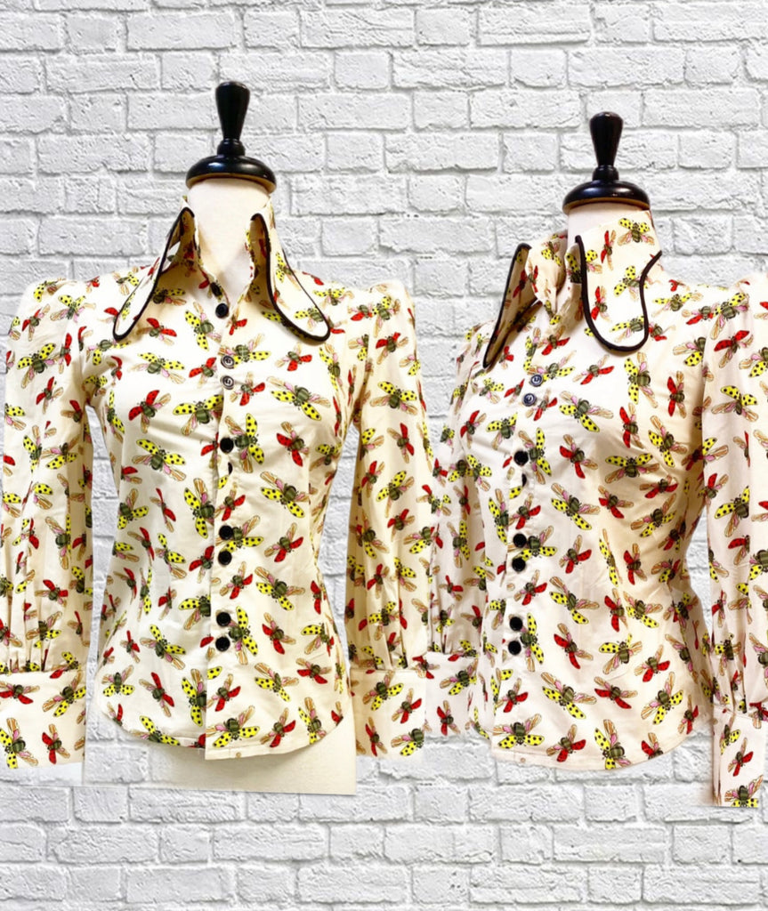 Mannequin busts showing the Ivy Blouse in Polka Dot Bees on Cream features an exaggerated collar, extra large cuffs, and bishop sleeves.