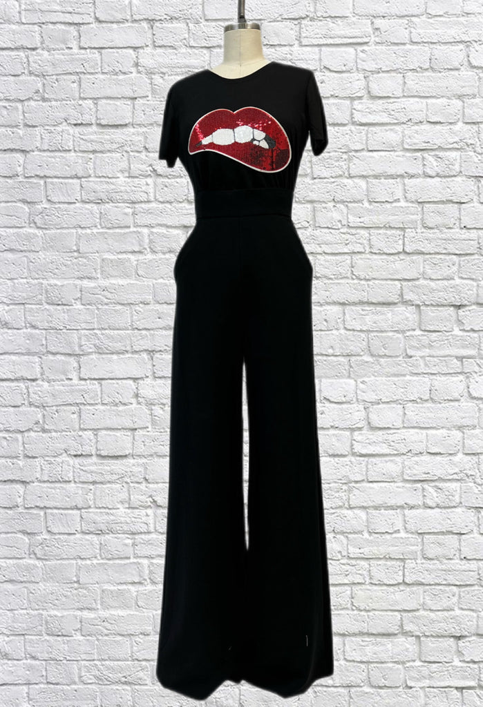 Mannequin form showing wide leg palazzo pants in black suiting, styled with a black graphic t-shirt.