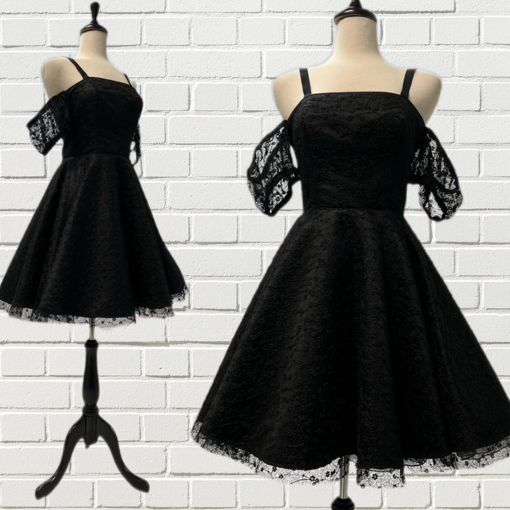 Loretta Cocktail dress in gorgeous black embroidered lace has a black Peau du Soie underlay, fitted bodice, full circle skirt, cold shoulder gathered puff sleeves, back zipper closure, and removable adjustable bra straps.