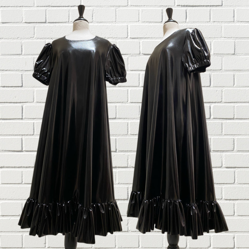 Oversized, short puffed sleeves, and full circle body with ruffle hemming in silky black PVC.