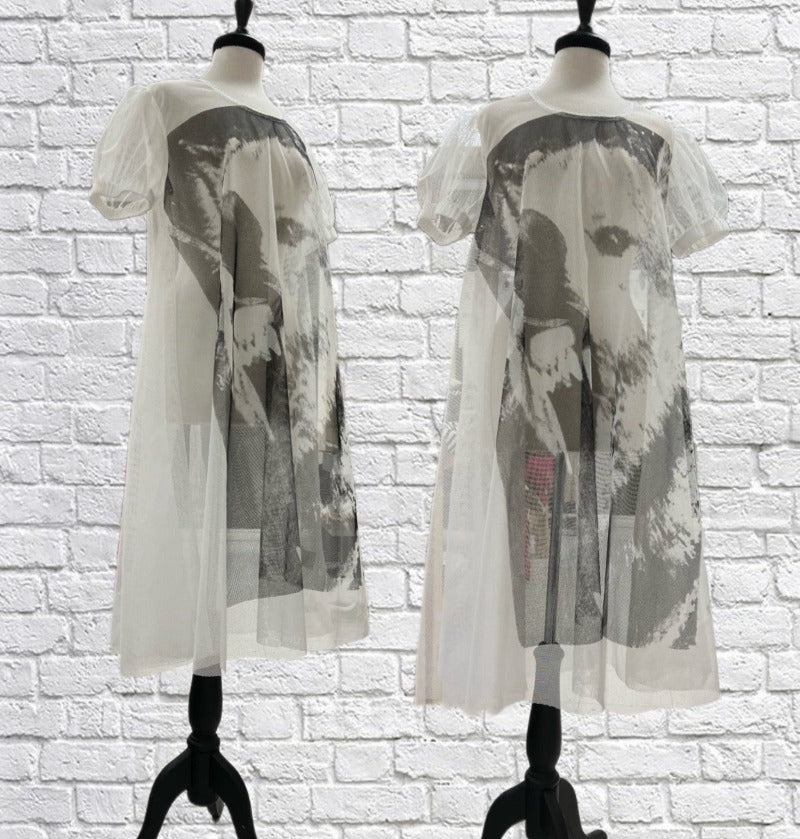 Mannequin forms showing the side and front profile of the Molly dress in lightweight White Mesh with puff short sleeves, full circle body and adorned with our giant Wolf print.