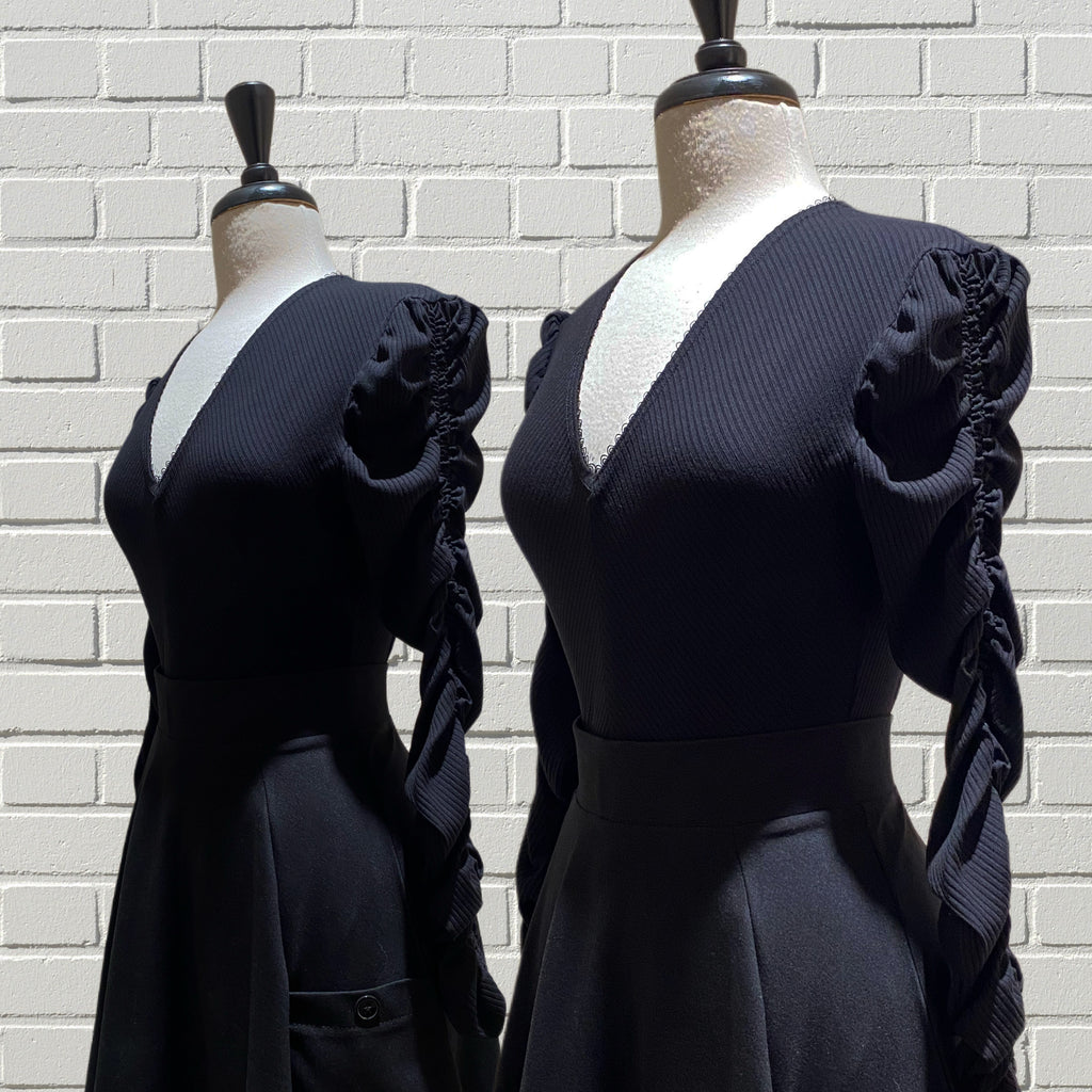 Mannequin busts showing our Ruby Tops with V-neck, long triple-ruched sleeves, and fitted bodice in Bamboo Ribbed Knit.