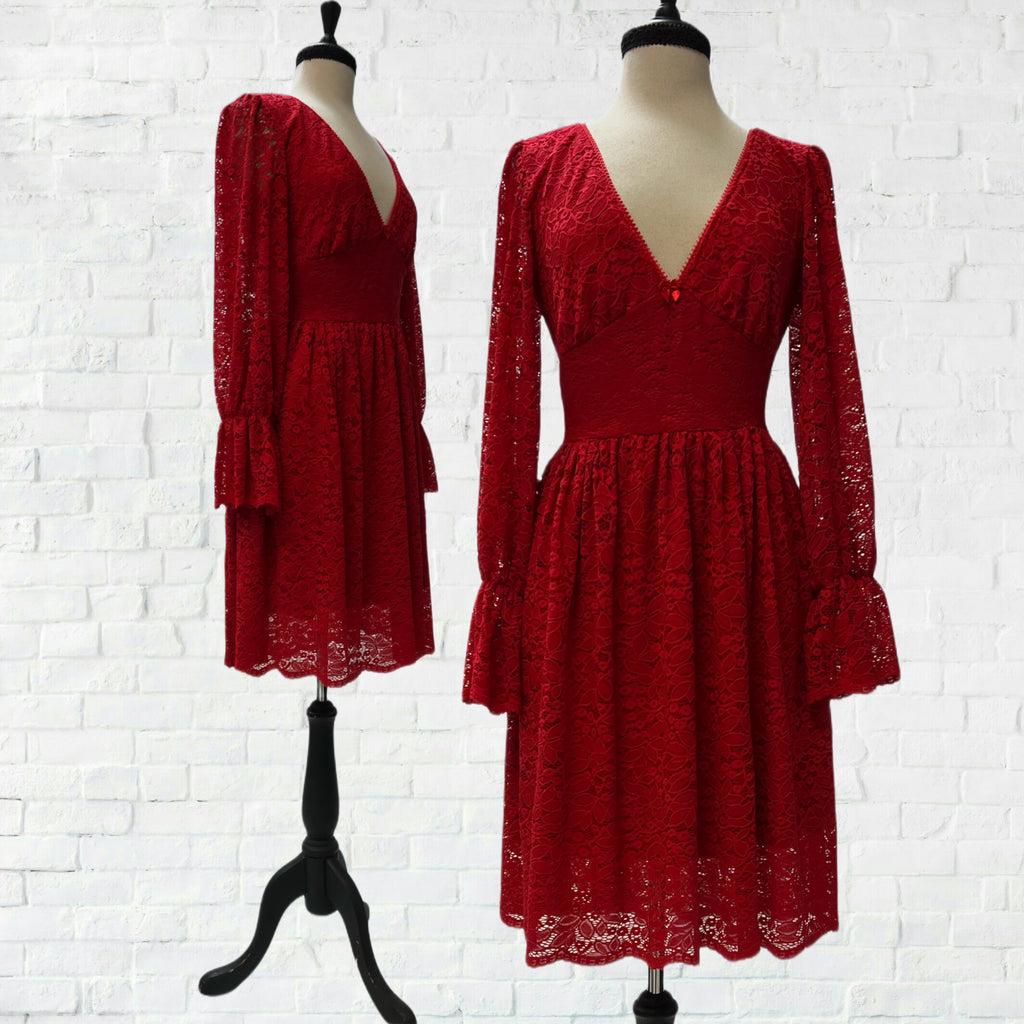 Mannequin form showing the Red stretch lace Siobhan baby doll dress with bamboo knit lining, empire waist, deep V-neck, long dramatic sleeves, and scalloped hem.