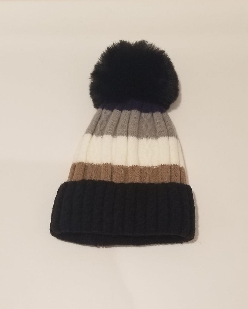 ﻿A thick knit toque lined with the softest felt, topped with an adorable pom-pom. Keep cozy without comprising style.  Available at Blackbird Studios Canada.