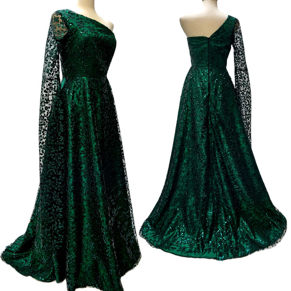 Two mannequin forms show the side and back profile of the Katie Gown in Emerald Green Sequin.  The Fit, the Fabric....it's beyond.  Sheer floral sequin over Emerald Green Peau du Soie.  Fitted bodice, A-Line maxi with a sweep train. One cold shoulder and one dramatic long sleeve.