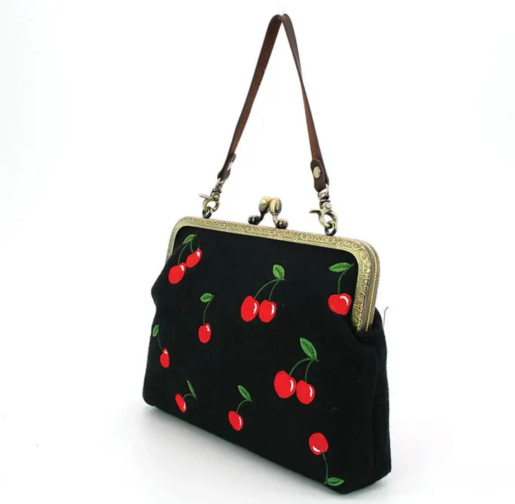 Embroidered cherries on a black handbag with brass hardware. The sweetest finish to any outfit! Available at Blackbird Canada.
