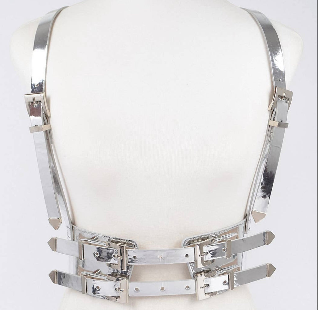 Silver fashion harness belt on a white mannequin bust.