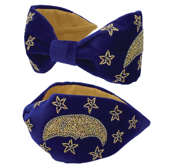 Royal blue velvet headband with gold beadwork in the shape of a crescent moon and stars across it. 